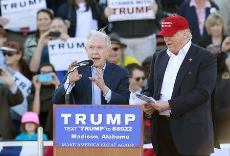 U.S. Senator Jeff Sessions speaks next to U.S. Republican presidential candidate Donald Trump at a rally at Madison City Schools Stadium in Madison, Alabama February 28, 2016. REUTERS/Marvin Gentry