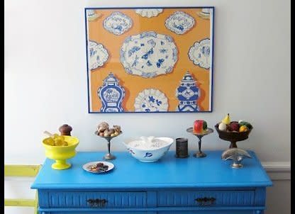 Rosen painted this a bright blue to match the framed sample of vintage Clarence House wallpaper. The other possessions include a Eva Zeisel covered dish from a thrift shop. 