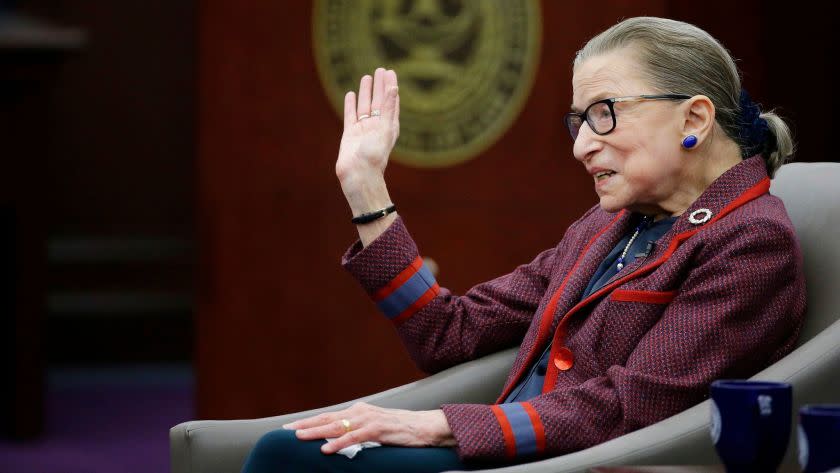 Supreme Court Justice Ruth Bader Ginsburg waves goodbye to those who came to listen and participate in her "fireside chat" in the Bruce M. Selya Appellate Courtroom at the Roger William University Law School on Tuesday, Jan. 30, 2018, in Bristol, R.I. (AP Photo/Stephan Savoia)