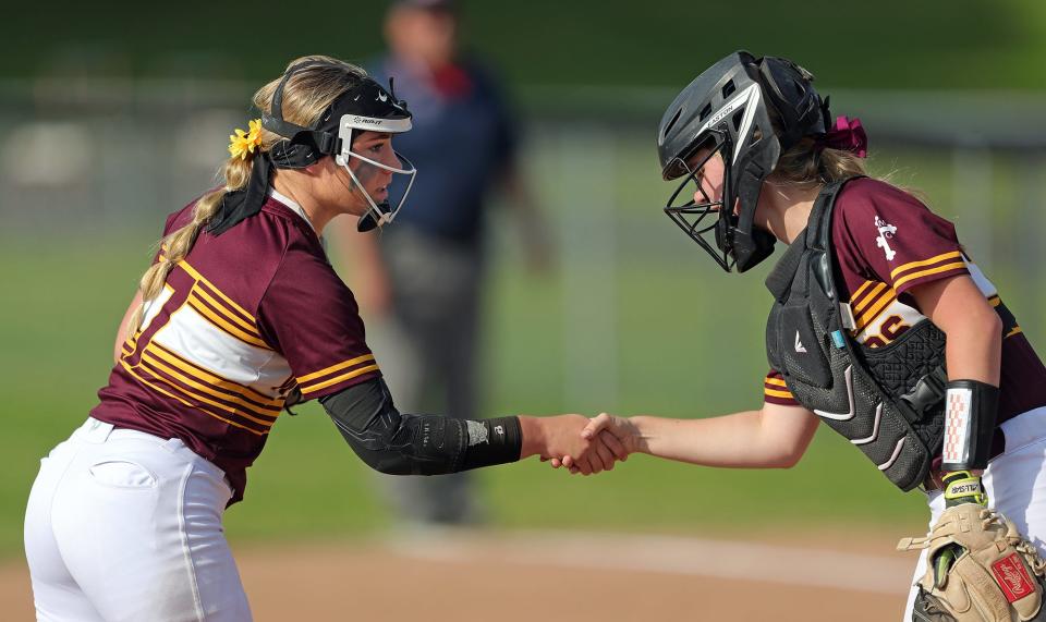 Walsh Jesuit pitcher Natalie Susa, left, shakes hands with catcher Caleigh Shaulis in between innings of a 2022 Division I district final in Massillon.