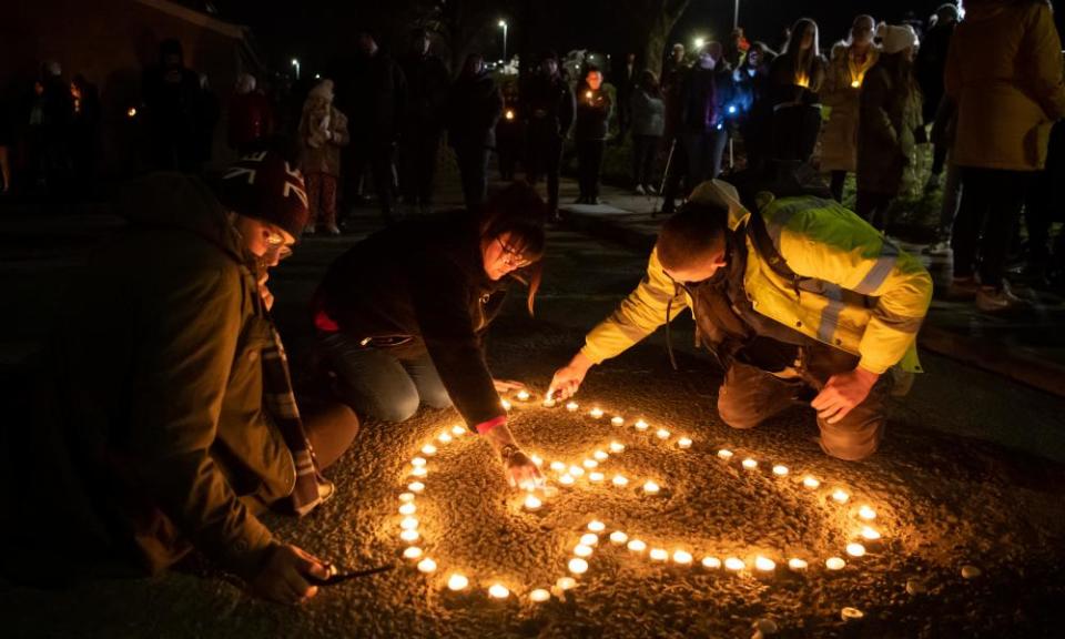 Family, friends and members of the public gather by the bus stop for a candlelit vigil in tribute of Bobbi-Anne McLeod on 25 November.