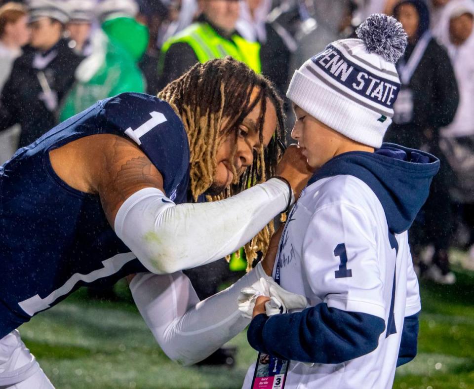 Penn State Saftey Jalen Reed signs a young fan’s jersey on the field after Penn State Football’s game against Iowa on Saturday, Sept. 23, 2023, at Beaver Stadium..