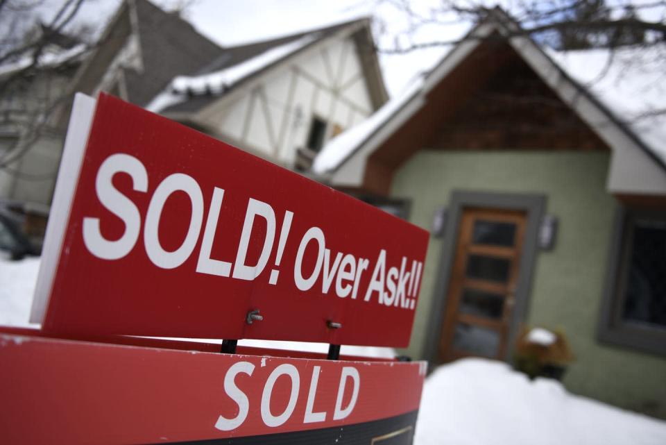 <span class="caption">A for sale sign outside a home indicates that it has sold for over the asking price, in Ottawa, in March 2021. House prices and rents have become increasingly more unaffordable in Ontario over the past few years.</span> <span class="attribution"><span class="source">THE CANADIAN PRESS/Justin Tang</span></span>