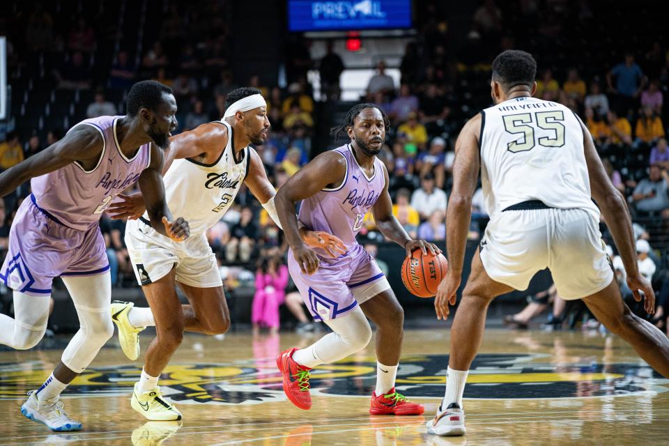 Former Kansas State star Jacob Pullen (0) looks for an opening against Team Colorado while playing for Purple Reign this summer in The Basketball Tournament at Wichita State's Koch Arena.