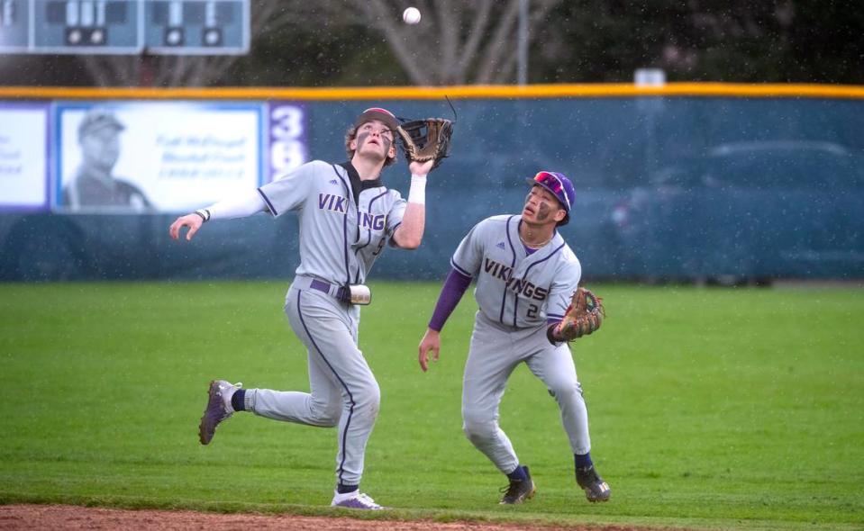 Puyallup’s Gage Thompson corrals a pop-up by Olympia’s Evan Nicol in front of teammate Mason Pike during Wednesday afternoon’s baseball game at Olympia High School in Olympia, Washington, on April 12, 2023. Puyallup won the game, 6-2.