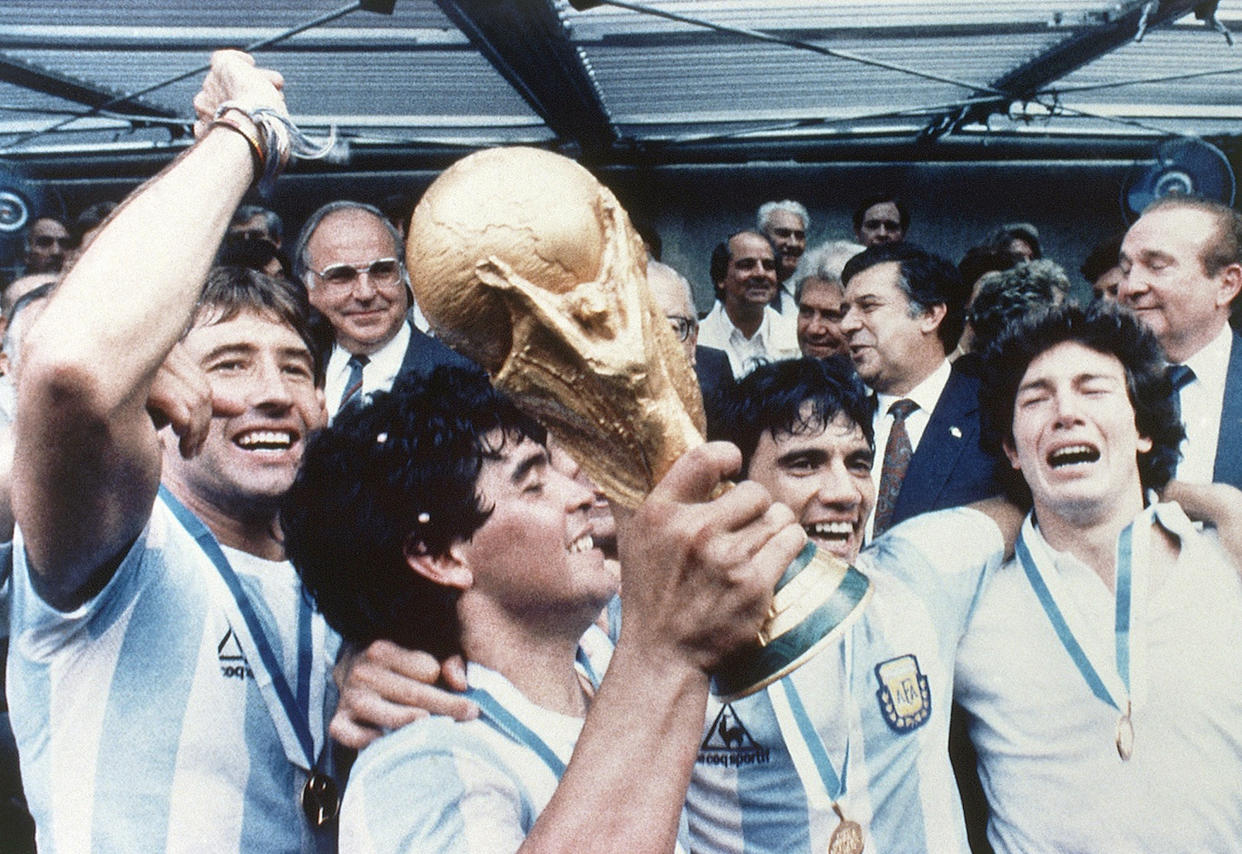 Diego Maradona of Argentina celebrates with the cup and his team mates at the end of the World  Cup soccer final in the Atzeca Stadium, in Mexico City, Mexico, on June 29, 1986. Argentina defeated West Germany 3-2 to take the trophy. (AP Photo)