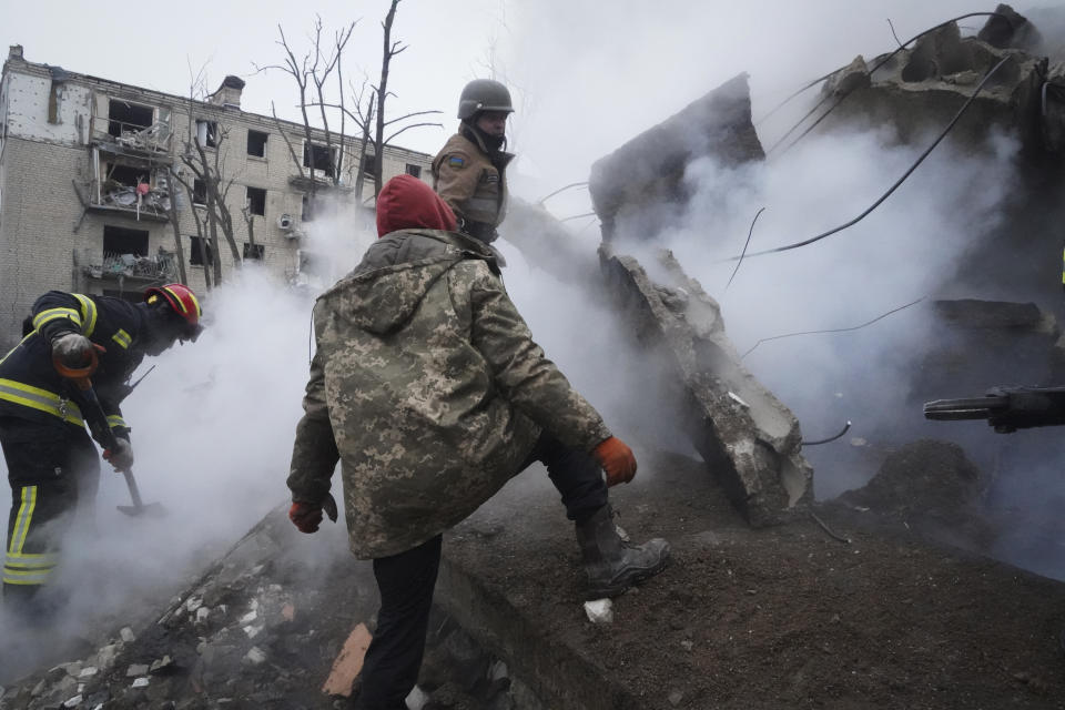 Rescuers work the scene of a building damaged by a Russian rocket attack in Kharkiv, Ukraine, Tuesday, Jan. 23, 2024. (AP Photo/Andrii Marienko)