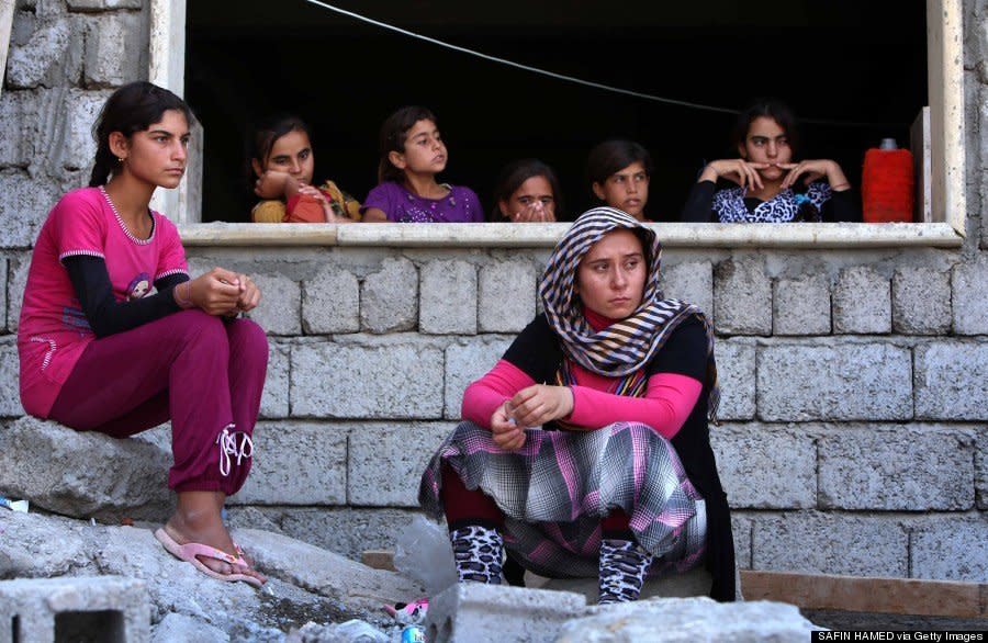Yazidi women who fled violence in the northern Iraqi town of Sinjar sit at a school where they are taking shelter in Dohuk on August 5, 2014. (SAFIN HAMED/AFP/Getty Images)