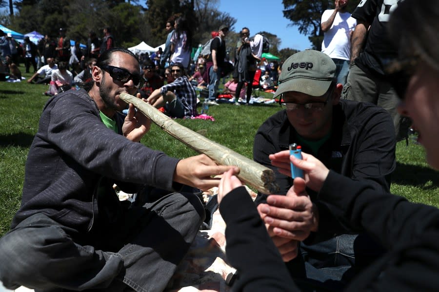 A marijuana user attempts to light an oversized joint during a celebration on Hippie Hill in Golden Gate Park on April 20, 2018 in San Francisco. (Photo by Justin Sullivan/ Getty Images /File)