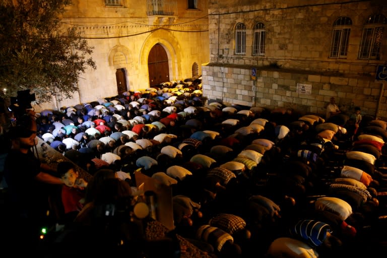 Palestinian Muslim worshippers pray outside Jerusalem's Old City on July 25, 2017