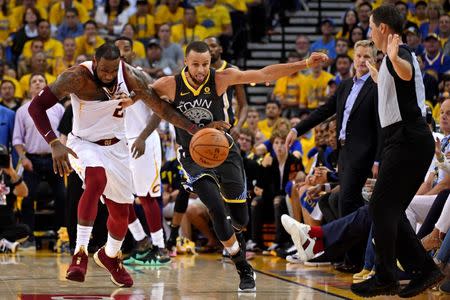 June 3, 2018; Oakland, CA, USA; Golden State Warriors guard Stephen Curry (30) and Cleveland Cavaliers forward LeBron James (23) go for a loose ball during the second quarter in game one of the 2018 NBA Finals at Oracle Arena. Kyle Terada-USA TODAY Sports