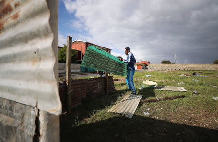 Father of seven, Muneer Baxter, works on a shack erected during illegal land occupations, in Mitchell's Plain township near Cape Town, South Africa, May 29, 2018. Picture taken May 29, 2018. REUTERS/Mike Hutchings