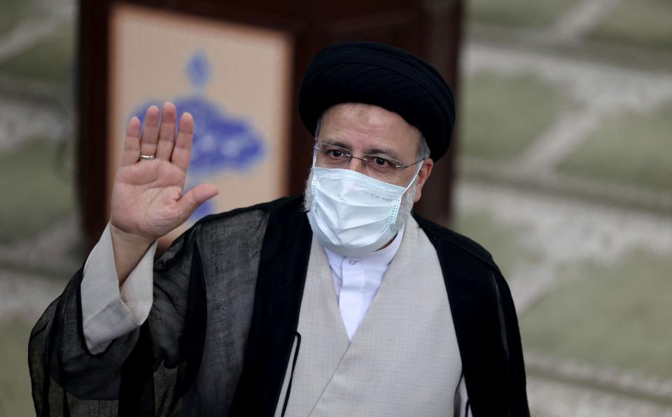 Iranian ultraconservative cleric and presidential candidate Ebrahim Raisi waves as he votes at a polling station in the capital Tehran, on June 18, 2021.