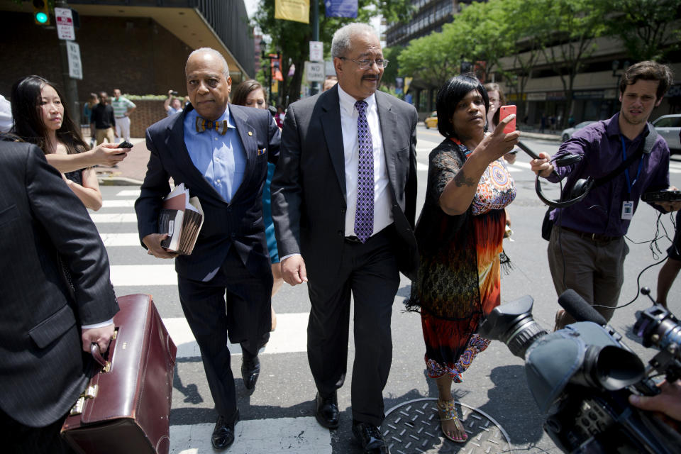FILE- In this June 21, 2016 file photo Rep. Chaka Fattah, D-Pa., center, leaves the federal courthouse in Philadelphia. Fattah, a longtime Pennsylvania congressman serving a 10-year prison term will ask a judge Friday, July 12, 2019, to reduce his sentence after four bribery and money laundering counts were thrown out on appeal. (AP Photo/Matt Rourke/File)