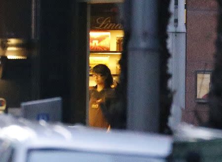 A woman is seen in a window of the Lindt cafe, where hostages are being held, at Martin Place in central Sydney December 15, 2014. REUTERS/David Gray