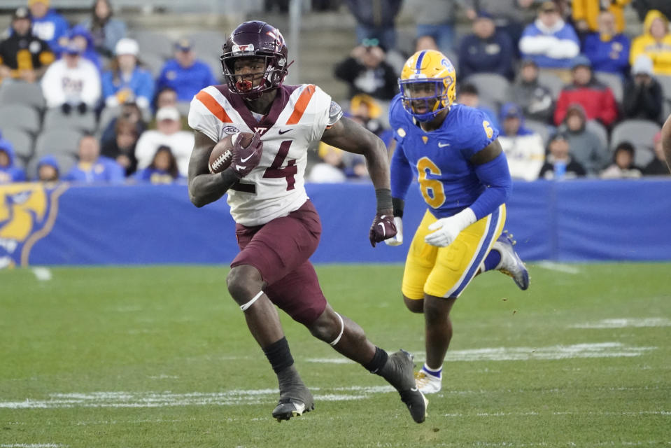 FILE - Virginia Tech running back Malachi Thomas (24) is chased by Pittsburgh defensive lineman John Morgan III (6) after making a catch during the second half of an NCAA college football game, Saturday, Oct. 8, 2022, in Pittsburgh. Virginia Tech opens their season at home against Old Dominion on Sept. 2. (AP Photo/Keith Srakocic, File)