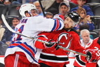 NEWARK, NJ - MAY 21: Derek Stepan #21 of the New York Rangers gets an elbow on Travis Zajac #19 of the New Jersey Devils in Game Four of the Eastern Conference Final during the 2012 NHL Stanley Cup Playoffs at the Prudential Center on May 21, 2012 in Newark, New Jersey. (Photo by Bruce Bennett/Getty Images)