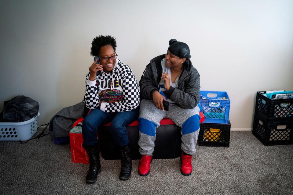 Tonya Hogan, 50, left, laughs with Tamarah Roberts, 38, after moving her belongings into her new apartment in Melvindale on Monday, May 1, 2023. "I'm in now, so we are finally able to rest and relax," said Hogan.