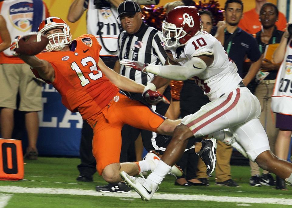 Clemson wide receiver Hunter Renfrow (13) can't take control of the ball as Oklahoma safety Steven Parker (10) defends, during the second half of the Orange Bowl NCAA college football semifinal playoff game, Thursday, Dec. 31, 2015, in Miami Gardens, Fla. (AP Photo/Lynne Sladky)