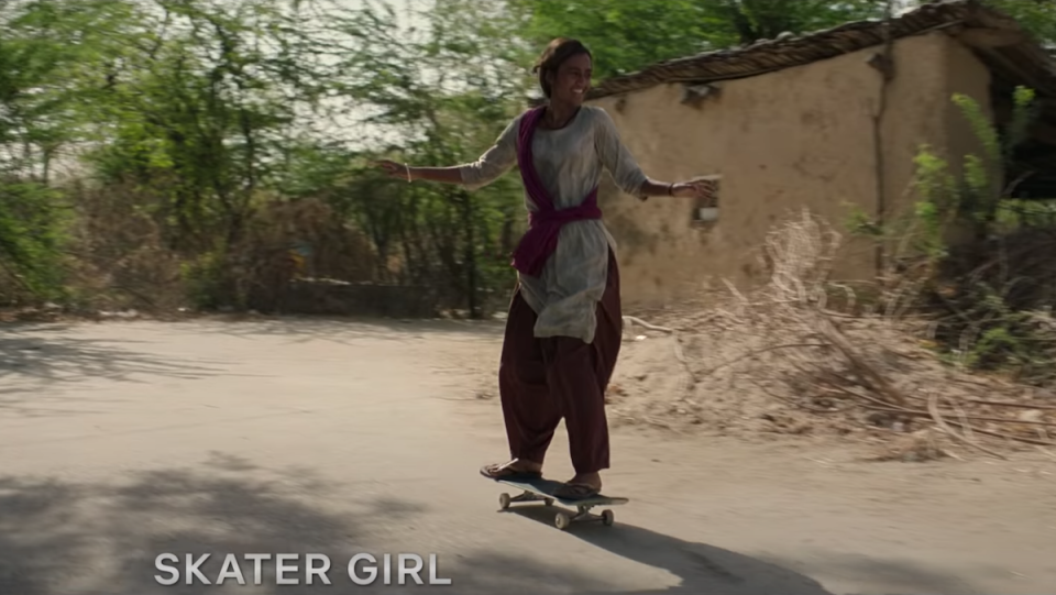 A young woman on a skateboard.