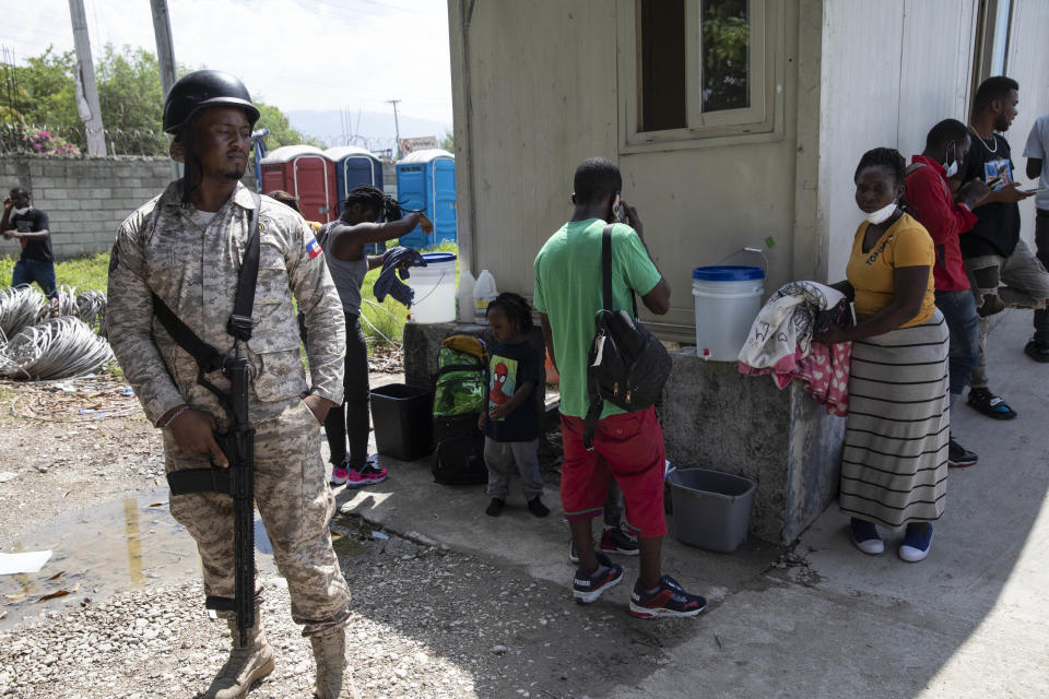 Haitian migrants deported from the US gather after landing at the Toussaint Louverture International Airport in Port-au-Prince, Haiti, Sunday, Sept. 19, 2021. Thousands of Haitian migrants have been arriving to Del Rio, Texas, to ask for asylum in the U.S., as authorities begin to deported them to back to Haiti which is in a worse shape than when they left. (AP Photo/Rodrigo Abd)