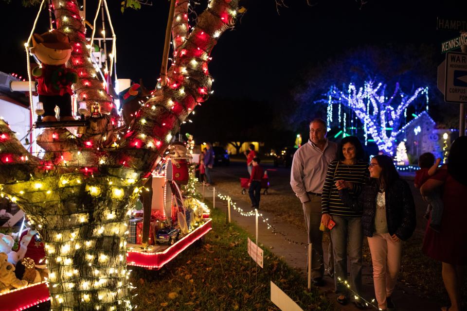 Residents look at Mr. Bill's Christmas decorations at his home on Hampton Street on Wednesday, Dec. 19, 2018.