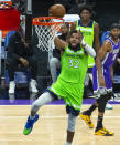 Minnesota Timberwolves center Karl-Anthony Towns (32) scores against the Sacramento Kings during the first quarter of an NBA basketball game in Sacramento, Calif., Tuesday, April 20, 2021. (AP Photo/Randall Benton)