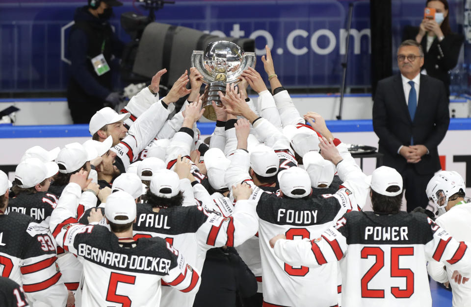 Canada's team players celebrate with the trophy after winning the Ice Hockey World Championship final match between Finland and Canada at the Arena in Riga, Latvia, Sunday, June 6, 2021. (AP Photo/Sergei Grits)