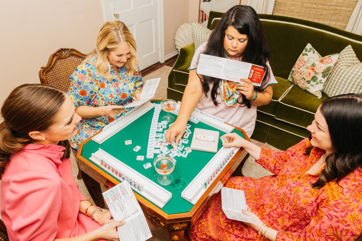 4 women playing a table game