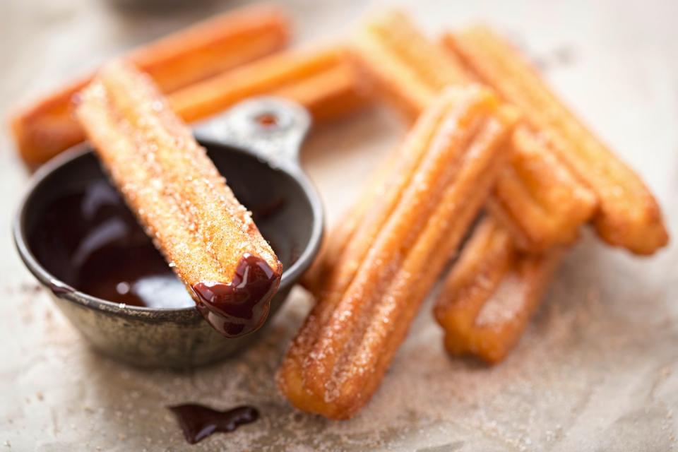 26) Make flan or churros for dessert.