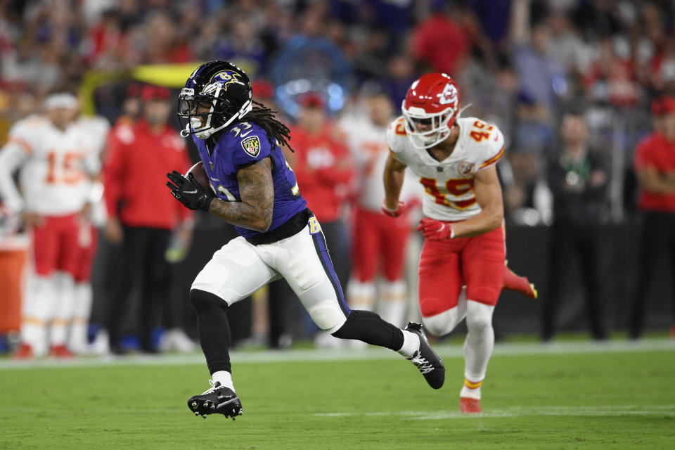 Baltimore Ravens running back Devonta Freeman, left, rushes past Kansas City Chiefs defensive back Daniel Sorensen in the first half of an NFL football game, Sunday, Sept. 19, 2021, in Baltimore. (AP Photo/Nick Wass)