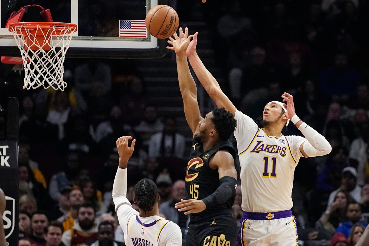 Lakers center Jaxson Hayes (11) defends Cavaliers guard Donovan Mitchell, Saturday, in Cleveland.