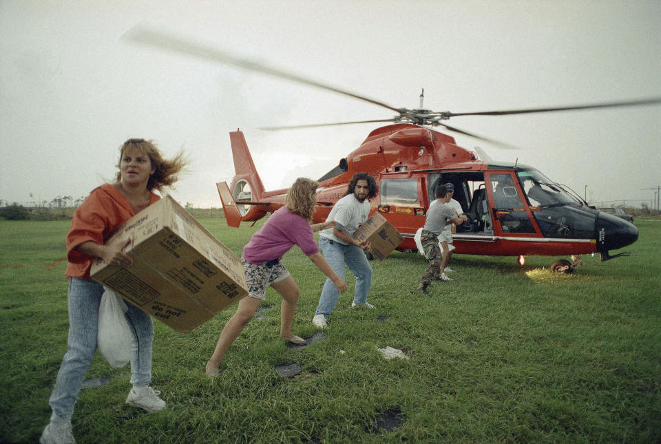 <p>Emergency supplies are taken off a military helicopter at the Campbell Middle School in Homestead, Fla., Aug. 29, 1992, for distribution to victims of Hurricane Andrew, which ripped through the area last Monday. More than 250,000 persons were left homeless in the storm. (AP Photo/David Bergman) </p>