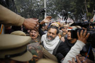 Swaraj India party chief Yogendra Yadav, center, is detained by police near the historic Red Fort in New Delhi, India, Thursday, Dec. 19, 2019. Police detained several hundred protestors in some of India's biggest cities Thursday as they defied a ban on assembly that authorities imposed to stem widespread demonstrations against a new citizenship law that opponents say threatens India's secular democracy. Dozens of demonstrations were to take place around country as opposition grows to a new citizenship law that excludes Muslims. The law has sparked anger at what many see as the government's push to bring India closer to a Hindu state. (AP Photo/Altaf Qadri)