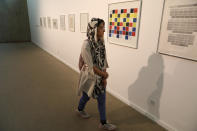 A visitor looks at artworks by the American artist Sol Lewitt while visiting a 19th and 20th-century American and European minimalist and conceptual masterpieces show at the Tehran Museum of Contemporary Art in Tehran, Iran, Tuesday, Aug. 2, 2022. Some of the world’s most prized works of contemporary Western art have been unveiled for the first time in decades — in Tehran. (AP Photo/Vahid Salemi)