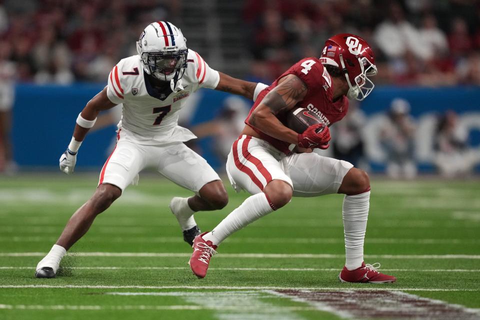 Dec 28, 2023; San Antonio, TX, USA; Oklahoma Sooners wide receiver Nic Anderson (4) catches the ball against Arizona Wildcats cornerback Ephesians Prysock (7) in the fist half of the Alamo Bowl at Alamodome. Mandatory Credit: Kirby Lee-USA TODAY Sports ORG XMIT: IMAGN-715788 ORIG FILE ID: 20231228_rgu_al2_174.JPG