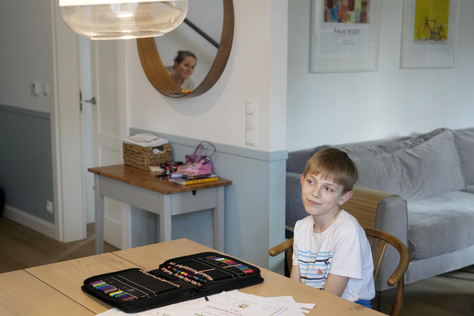 Julian Kozak, 9, sits at the table where he used to do his homework at the family home in Warsaw, Poland, Friday, April 5, 2024. Julian is not very happy that Poland's government has ordered strict limits on the amount of homework that teachers can impose on the lower grades, starting in April. (AP Photo/Czarek Sokolowski)