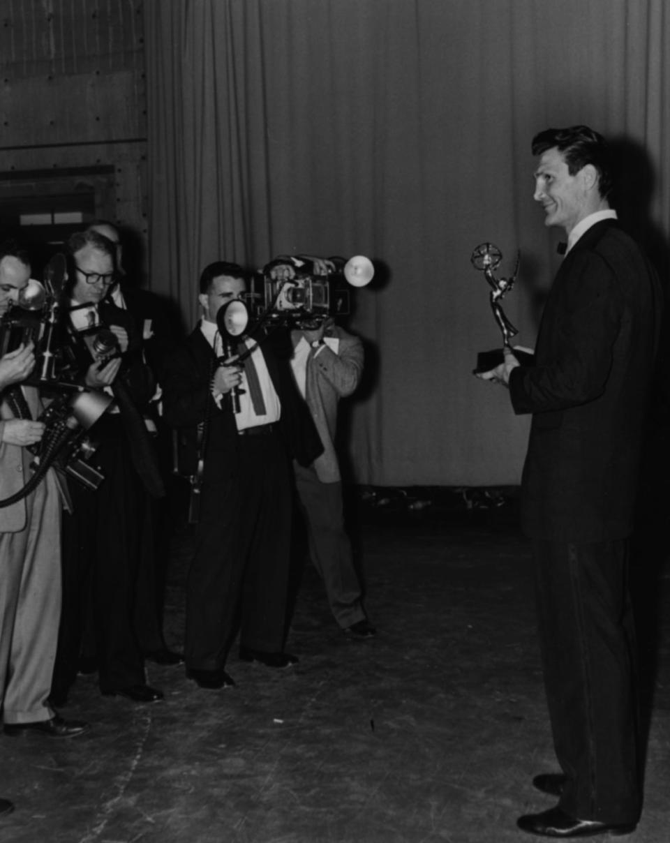 <p>A row of photographers capture Emmy-winner Jack Palance (<em>Playhouse 60</em>) posing with his trophy. He took home the award for Best Single Performance.</p>