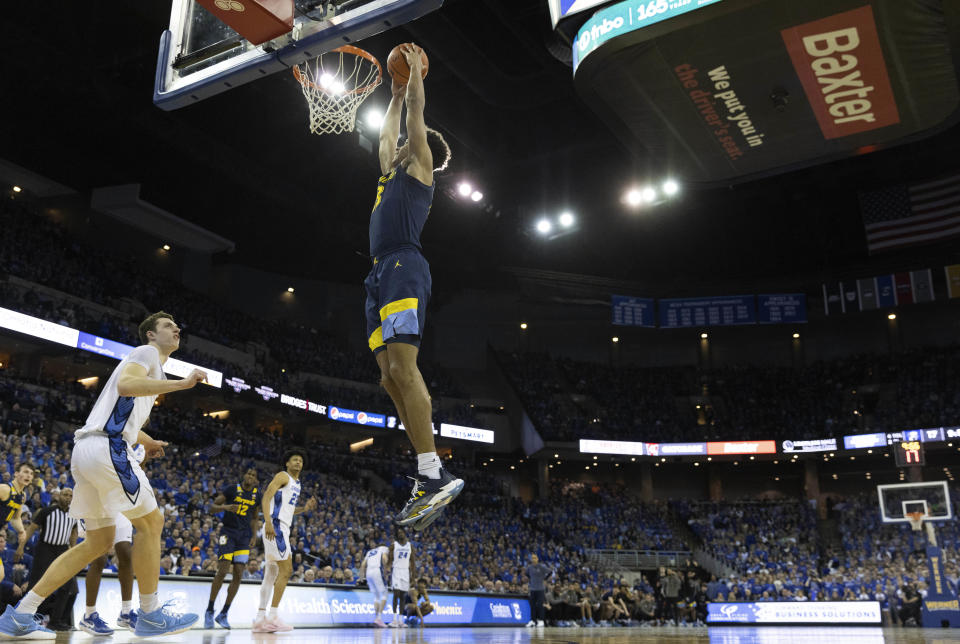 Marquette's Oso Ighodaro, right, dunks against Creighton's Ryan Kalkbrenner during the first half of an NCAA college basketball game on Tuesday, Feb. 21, 2023, in Omaha, Neb. (AP Photo/Rebecca S. Gratz)