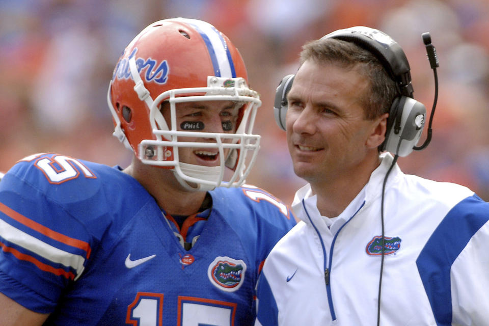 FILE - In this Oct. 25, 2008, file photo, Florida quarterback Tim Tebow (15) shares a laugh with coach Urban Meyer during the fourth quarter of an NCAA college football game against Kentucky in Gainesville, Fla. Tebow and Meyer are together again, this time in the NFL and with Tebow playing a new position. The former Florida star and 2007 Heisman Trophy-winning quarterback signed a one-year contract with the Jacksonville Jaguars on Thursday, May 20, 2021, and will attempt to revive his pro career as a tight end. (AP Photo/Phil Sandlin, File)