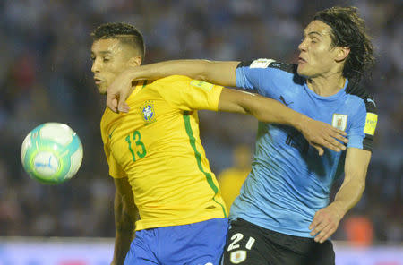 Football Soccer - Uruguay v Brazil - World Cup 2018 Qualifiers - Centenario stadium, Montevideo, Uruguay - 23/3/17 - Uruguay's Edinson Cavani (21) and Brazil's Marquinhos in action. REUTERS/Carlos Pazos