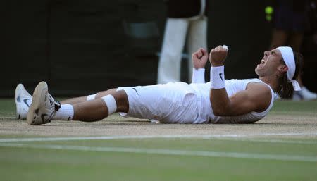 FILE PHOTO: Rafael Nadal of Spain celebrates defeating Roger Federer of Switzerland in their finals match at the Wimbledon tennis championships in London, Britain, July 6, 2008. REUTERS/Toby Melville/File Photo