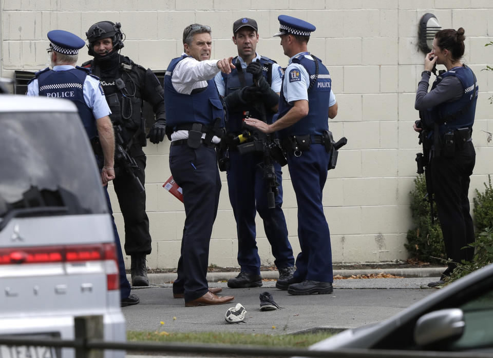 FILE - In this March 15, 2019, file photo, police stand outside a mosque in central Christchurch, New Zealand. New Zealand police on Wednesday, April 17, 2019 released a detailed timeline of their response to the March 15 shootings that left 50 dead at two Christchurch mosques, confirming they arrested the suspected shooter 18 minutes after receiving the first emergency call. (AP Photo/Mark Baker, File)