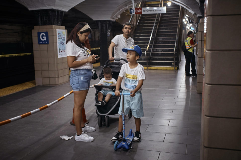 Migrant Darwin Salinas, top, travels with his wife Kimberly Carchipulla, left, his son Damien, 6, right, and Derek, 1, center, Sunday, June 16, 2024, Jersey City, N.J. Thousands of migrant families in New York City are facing a summer of uncertainty for their school-aged children with a citywide limit of 60 days in a shelter before needing to reapply or find their own. (AP Photo/Andres Kudacki)