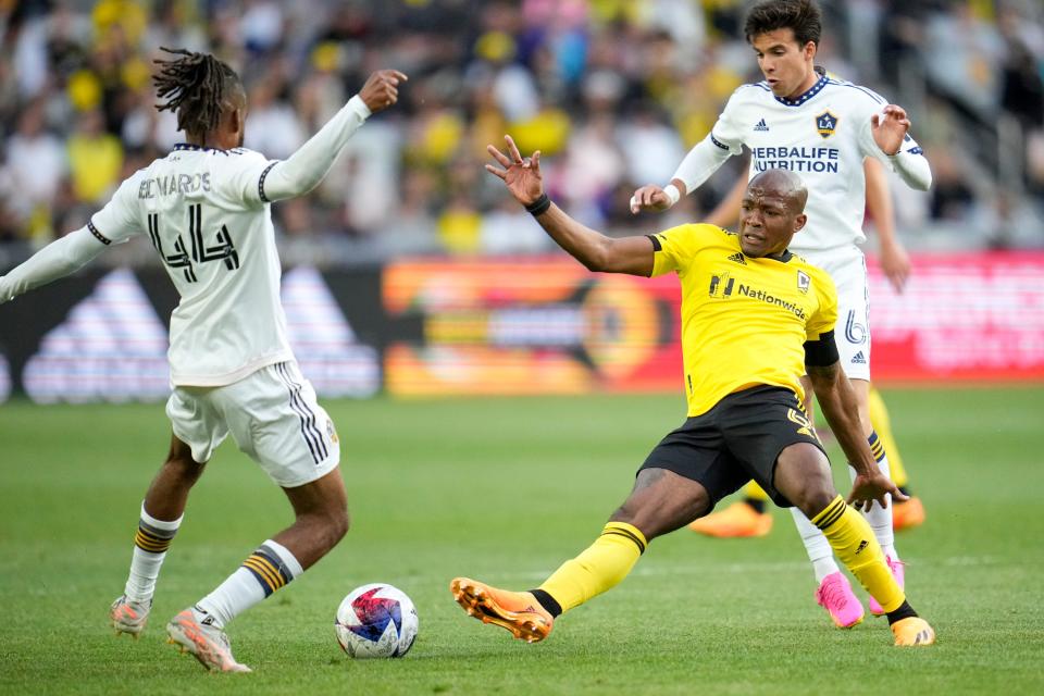 May 17, 2023; Columbus, Ohio, USA;  Columbus Crew midfielder Darlington Nagbe (6) contests the ball with Los Angeles Galaxy forward Raheem Edwards (44) and midfielder Riqui Puig (6) during the first half of the MLS soccer game between Columbus Crew and LA Galaxy at Lower.com Field on May 17, 2023. 