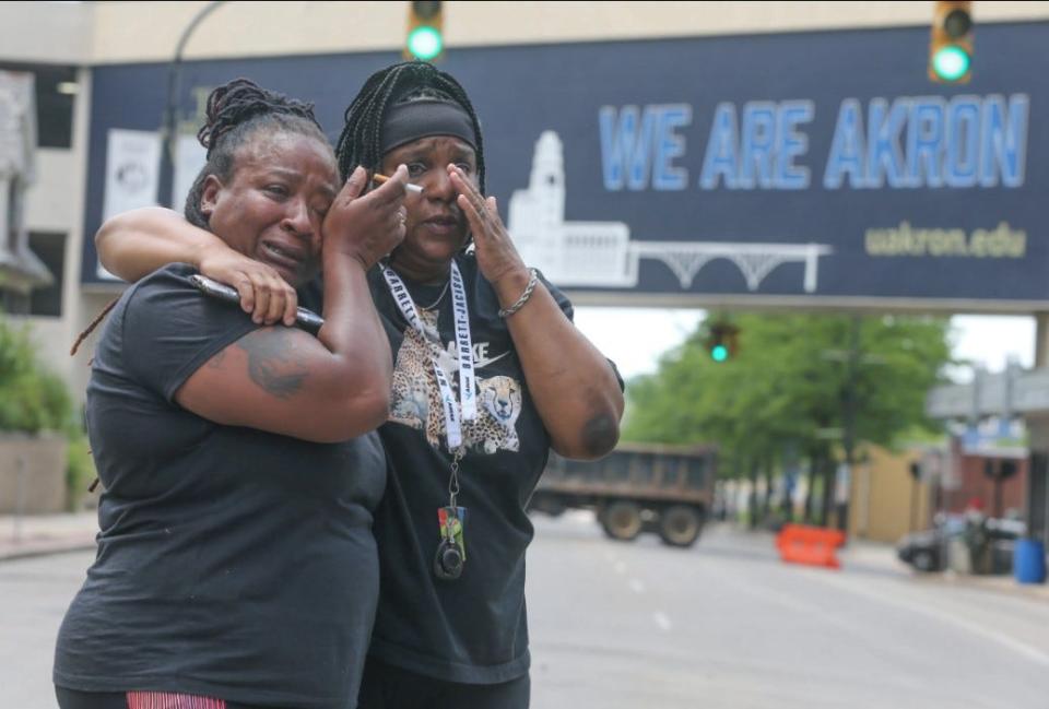 Sandra Dees, left, and Marquita Carter stand tearfully in front of the Harold K. Stubbs Justice Center in Akron on Sunday after viewing police bodycam footage of Jayland Walker's fatal shooting.