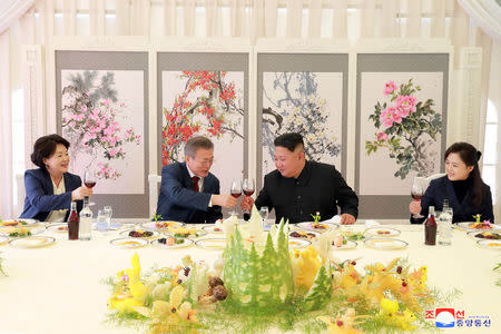 South Korea's first lady Kim Jung-sook, South Korean President Moon Jae-in, North Korean leader Kim Jong Un and his wife Ri Sol Ju toast during a luncheon, in this photo released by North Korea's Korean Central News Agency (KCNA) on September 21, 2018. KCNA via REUTERS