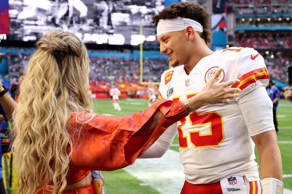 Patrick Mahomes #15 of the Kansas City Chiefs hugs his wife Brittany Mahomes before playing against the Philadelphia Eagles Super Bowl LVII at State Farm Stadium on February 12, 2023 in Glendale, Arizona.
