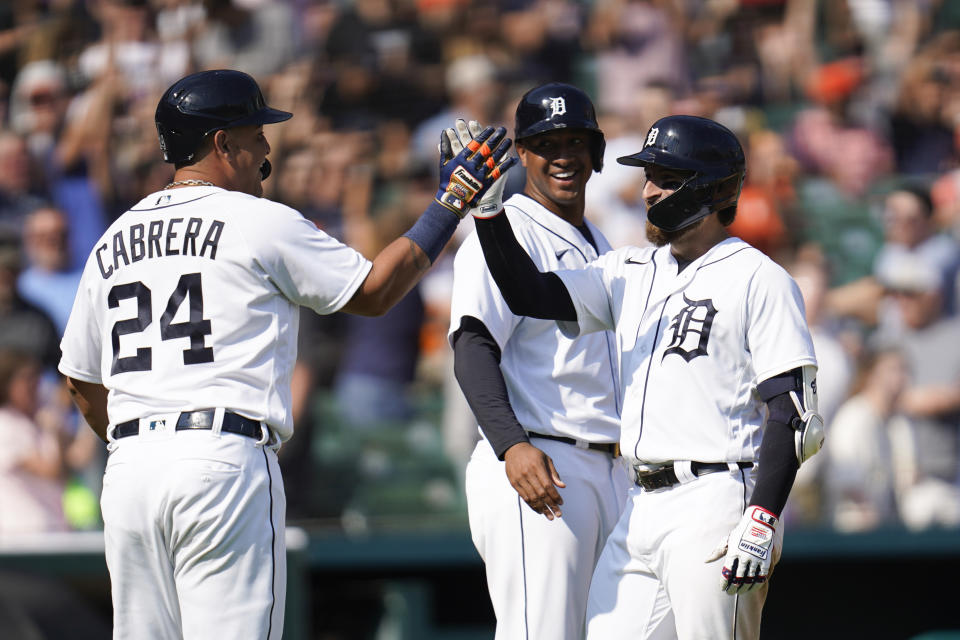 Detroit Tigers' Eric Haase, right, celebrates his three run inside-the-park home run with Miguel Cabrera (24) and Jonathan Schoop, middle in the fourth inning of a baseball game against the Chicago White Sox in Detroit, Saturday, July 3, 2021. (AP Photo/Paul Sancya)