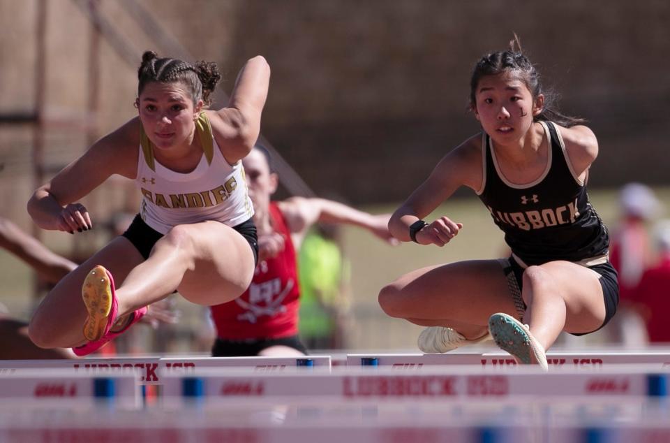 Amarillo High's Keely Harper, left, and Lubbock High's Sara Dy compete in the 100-meter hurdles during the Districts 3/4-5A area track and field meet, Friday, April 21, 2023, at Lowrey Field at PlainsCapital Park.